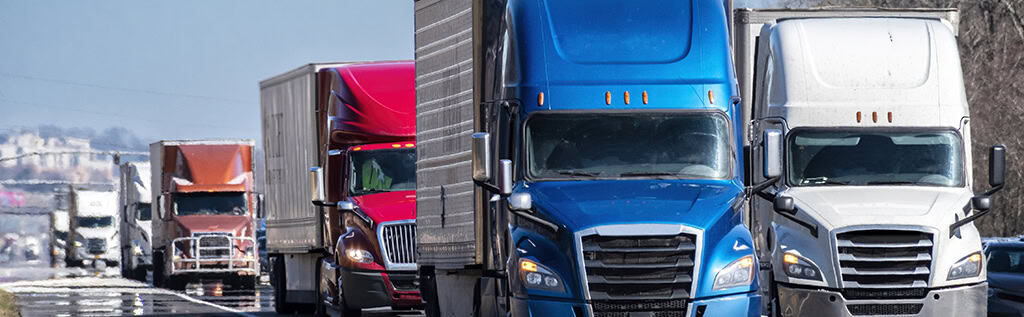 Convoy of 18 wheeler trucks on the road